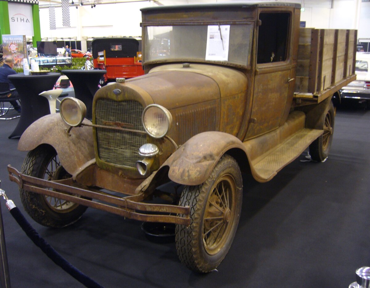 Ford Model AA. Bei diesem stark patinierten Truck handelt es sich um einen  Scheunenfund  aus dem US-Bundesstaat Kansas. Er basiert auf der Technik des 1928 vorgestellten Ford Model A. Beim gezeigten Truck dürfte es sich um ein Modell der Baujahre 1930 oder 1931 handeln, da die vorderen Scheinwerfer schon an der gebogenen Haltestange montiert sind. Der Vierzylinderreihenmotor hat einen Hubraum von 3285 cm³ und leistet 40 PS. Die LKW der Modellreihe AA, auch  Ford Schnell-Lastwagen“ genannt, wurden ab 1928 auch auf den deutschen Markt angeboten. Sie wurden in Berlin montiert. Ab Mai 1931 erfolgte die Produktion dann im neuen Ford-Werk in Köln. Ein Lastwagen des Modell AA war somit das erste Modell, welches im  Made in Cologne“ vom Band lief. Der LKW mit einer Nutzlast von 1.5to konnte mit zwei verschiedenen Radständen, sowie mit hinterer Einzel- oder Zwillingsbereifung bestellt werden. Essen Motor Show am 04.12.2024.