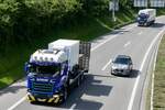 Ein Scania mit Ladefläche von Reinhard Recycling am 28.6.24 auf der Anfahrt zum Trucker Festival auf der A8 in Matten b. Interlaken.
